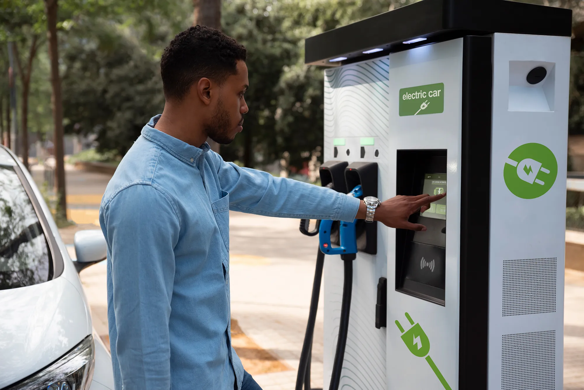 side-view-man-charging-electric-car 1